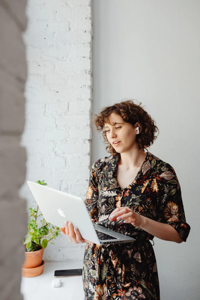 e-satisfaction team member reviewing customer feedback on a laptop